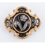 A Victorian yellow metal mourning design brooch with black onyx domed centre having an applied