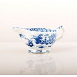 A small Bow blue and white sauceboat, Pylon Trees pattern, 1750's lightly fluted, length 11cm.