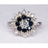 A sapphire and diamond circular cluster ring,