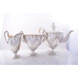 A Victorian silver three piece pedestal tea set, by Martin Hall & Co.
