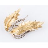 A diamond set yellow metal double leaf spray brooch,