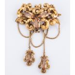 A Victorian yellow metal hollow scroll design brooch,