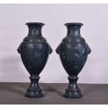 A pair of large veined grey marble amphora urns, each with lion mask handles, circular bases,