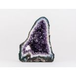 An amethyst half geode of good colour displaying crystals with trigonal symmetry.