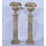 A pair of alabaster campana urns on pedestals, perhaps Italian, circa 1900, segmentary,