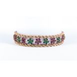 A ruby and emerald yellow metal bracelet,