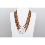 A bronze colour five strand pearl necklace having Mother of Pearl spheres to front.