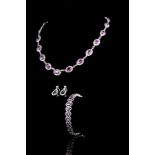 A pink sapphire and diamond suite of necklace, bracelet and earrings.