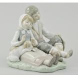 Lladro group of a seated boy and girl with puppy, 16cm.