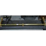 A cast iron fender with brass rails, 129cm wide together with two small pierced fenders ,