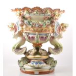 Continental pottery campana shaped urn, moulded decoration of floral swags, with winged mermaids,