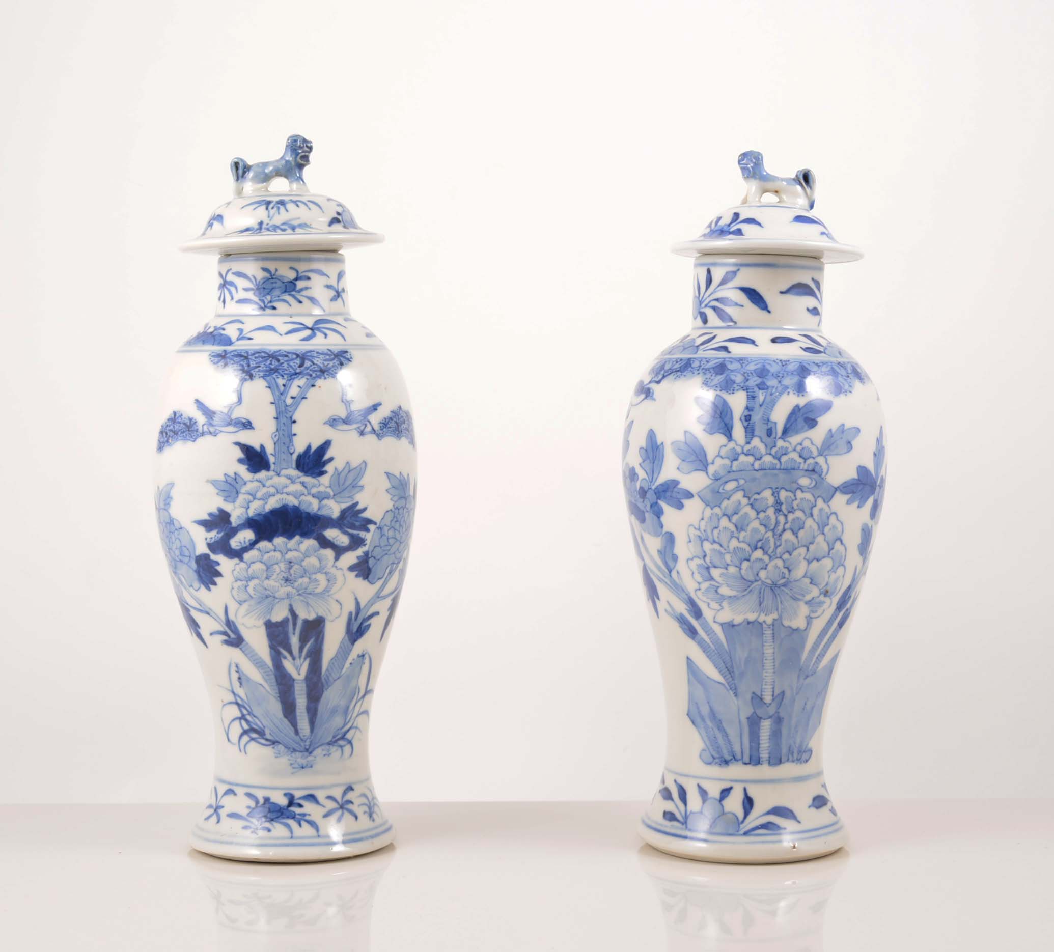 Pair of Chinese blue and white baluster shape vases, floral decoration with domed lids, 27cm,