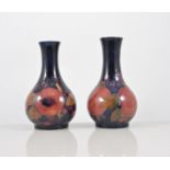 William Moorcroft, a pair of "Pomegranate" vases, circa 1925, stamped factory marks, green initials,