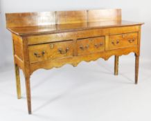 A 19th century Continental fruitwood dresser, probably French, with raised back and three frieze