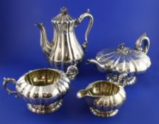 A matched William IV and Victorian four piece silver tea and coffee set, of melon shape, with floral