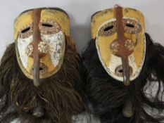 Papua New Guinea Sepik River, two similar carved wooden ceremonial masks, each with integral