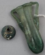 Two Roman green glass vessels, c.2nd century AD, the first a small baluster shaped vase, 3cm, the