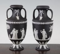 A pair of Wedgwood black jasper vases, early 20th century, each applied with figures emblematic of