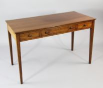 A George III mahogany rectangular writing table, fitted three frieze drawers with bun handles, on