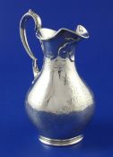 A Victorian silver baluster cream jug by Edward & John Barnard, with engraved foliate decoration and