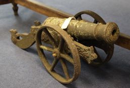 A late 19th / early 20th century cast iron cannon, with multi staged barrel and spoked wheels, 18.