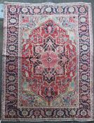 A Heriz carpet, with central foliate motif within a geometric foliate field on a red and ivory