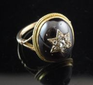 A Victorian 15ct gold, oval cabochon garnet and diamond ring, with old mine and rose cut diamond set