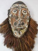 A Papua New Guinea Sepik River large carved wooden gable mask, polychrome decorated, with protruding