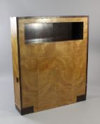 An Art Deco satinwood and Madagascar ebony side cabinet, with rectangular open space mounted with