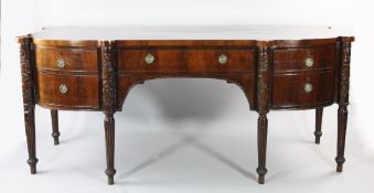 A George III mahogany sideboard, fitted with various cupboards and drawers with projecting columns