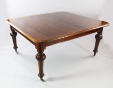 A Victorian mahogany extending dining table, with two extra leaves, on floral carved tapering