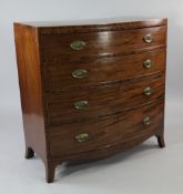 An early 19th century mahogany bow front chest, of four long graduated drawers, on splayed bracket