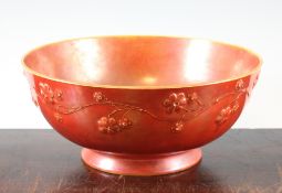 An unusual Ruskin orange lustre bowl, c.1910, the exterior applied with trailing flowers, on a