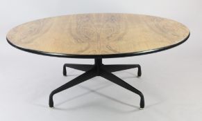 A Herman Miller low circular rosewood top table, in the manner of George Nelson, the black painted
