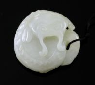 A Chinese pale celadon jade carving of a mud fish, the fish curled up, the stone with some light