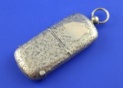 An Edwardian 9ct gold combination vesta and sovereign case, with engraved foliate scroll decoration,