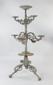 A Victorian style grey painted cast iron plant stand, with central circular bowl over six pierced