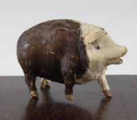 An early 20th century musical pig, probably French, with tail operated mechanism, 5.5in.