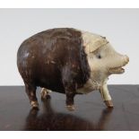 An early 20th century musical pig, probably French, with tail operated mechanism, 5.5in.