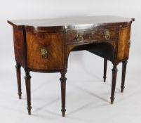 A Regency mahogany breakfront sideboard, with central frieze drawer between two bow end cupboard