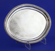 A George III silver oval teapot stand by Alice & George Burrows II, with gadrooned border, on
