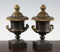 A pair of early 20th century French bronze cassolettes, of campana urn form, the reversible lids