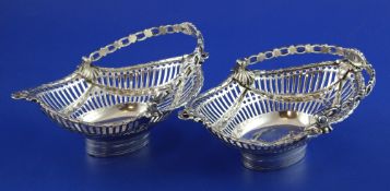 A pair of George III pierced silver epergne baskets, of oval form, with foliate swag decoration,