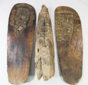 A Papua New Guinea Sepik River wooden ancestor spirit board, carved with triple masks; and two other