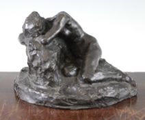 John Tweed (British, 1869-1933). A patinated bronze model of a recumbent female nude, on a rocky