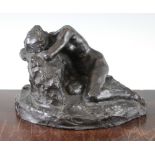 John Tweed (British, 1869-1933). A patinated bronze model of a recumbent female nude, on a rocky