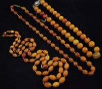 Two single strand graduated amber bead necklaces and one other round bead necklace with paste set