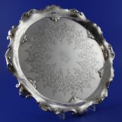 A Victorian silver salver by Edward & John Barnard, of shaped circular form, with scroll border