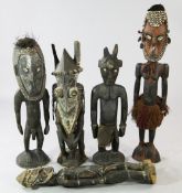 A Papua New Guinea Sepik River carved wooden female ancestor figure, painted and applied with cowrie