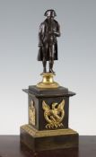 A late 19th / early 20th century French bronze and ormolu figure of Napoleon, on a circular socle